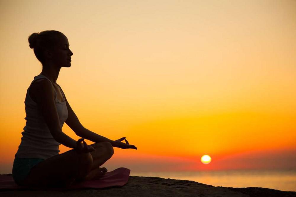 Yoga meditation at sunset